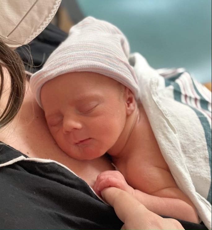 Baby Save Gus sleeps on his mom's chest